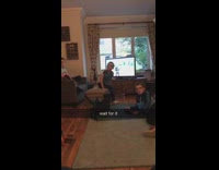 Three kids sit living room dab dog 