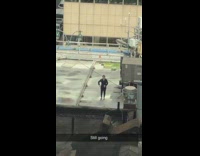 Black shirt guy dances alone rooftop music 