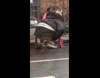 Woman pulls down pants, squats and pee on side of road