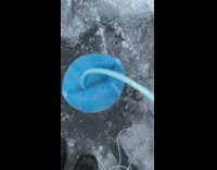 Long blue foam comes out of snow covered pipe 