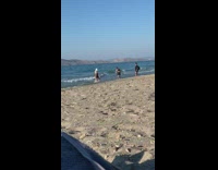 Girl black dress white hat spin beach