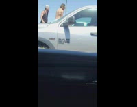 Two men goes elbow to elbow at the parking lot