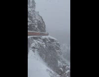 Train traveling through snowy mountain 
