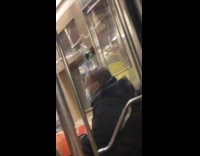 Man balances bottle on head in train