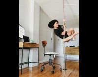 Woman pole dances work from home
