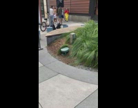 Man shirtless with white shorts poses in the sidewalk
