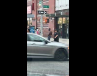 Man working out with resistance band with pedestrian light pole
