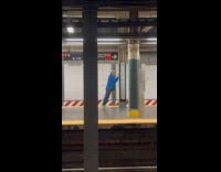 Man blue jacket standing push ups subway