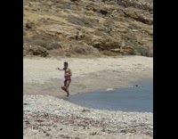 Man red brief dance point around beach