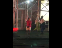 Lady does stretching under scaffolding at sidewalk