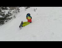 Little boy on snowboard jumps and falls 