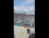 Bunch of people jump in pool to edm 