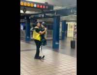 Man dance with skeleton in subway station
