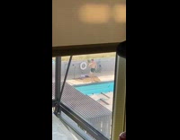 Guy black shorts brown hat dance pool