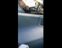 Black jacket grandpa in car plays harmonica 