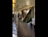 Guy lays in hammock on the subway