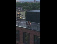 Woman twerks for camera and guy on chair 