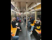 guy covered in gold and blue balloons