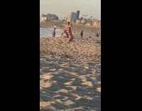 Man striped shorts flex muscles beach sunset
