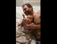 Dad tapping babys mouth while making sound 