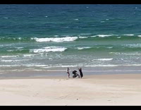 Collab IITW - Woman in white bikini jogs with a stroller at the beach