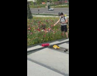 Striped shirt guy girl lays in flowers 