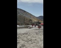 Girl white hat lay side sand rock