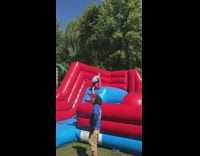 Boy jumps on red balls in inflatable obstacle course and scorpions between circles