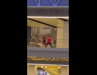 Couple dance at upper floor of train hall