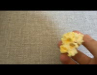 Person hold large piece of popcorn sofa
