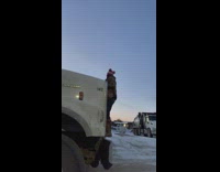 Person opens up the front hood of a big rig truck