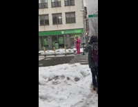 Pink suit guy with megaphone on crosswalk 