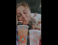 Woman teaches her dog to drink from straw 