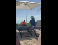 Man Records Lady Plays Flute by the Windy Beach