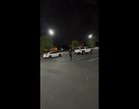 Guy swings at whip at parking lot 