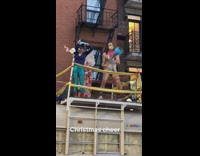 three hippies dance to music on white school bus