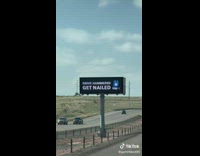 Drive hammered get nailed sign on freeway 