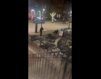 Woman poses on snowy sidewalk for photo