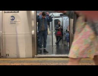 Live orchestra plays violin music at subway station, passengers board on train 