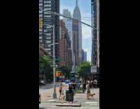 Collab WINY - Man dances on the sidewalk near a green garbage can