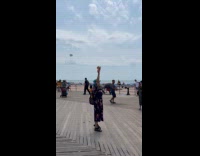 Collab WINY - Woman hold food up on the beach