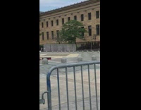 Woman red top lift barbell video shoot protest