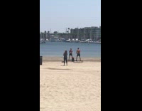 Two guys shorts jump trampoline workout beach