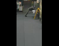 Man does push ups off a bench at train station