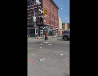 Guy throws napkins in street 