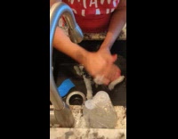 Black cat hates bath howls on sink