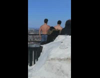 Guys take shirt off mountain for photo