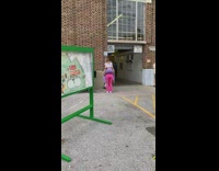 Woman in pink leggings carried by woman in violet leggings