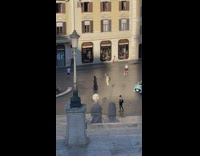 Woman in dress walks and poses on the street
