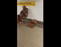 Bronze human statue guy chair broom station